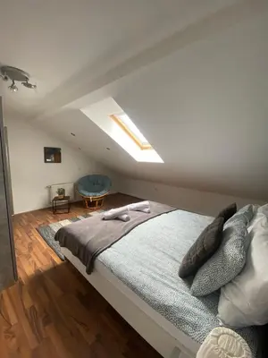 a bedroom with a large bed in a attic at Apartma Špela in Slivnica pri Mariboru