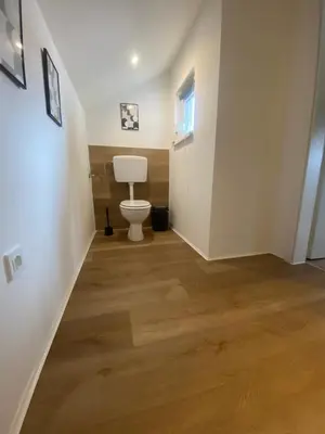 a bathroom with a toilet in the middle of a hallway at Apartma Špela in Slivnica pri Mariboru