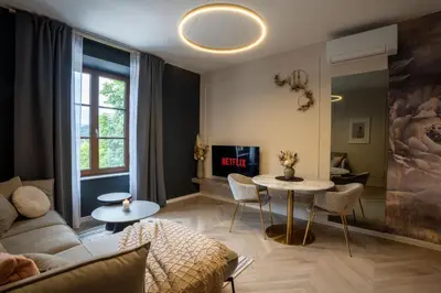 a living room with a couch and a table at Kalan Boutique Stay in Žirovnica