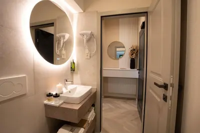 a bathroom with a sink and a mirror at Kalan Boutique Stay in Žirovnica