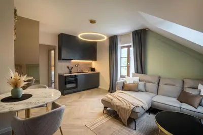 a living room with a couch and a table at Kalan Boutique Stay in Žirovnica