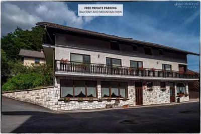 a building with a balcony on top of it at Turistična kmetija Markun in Golnik