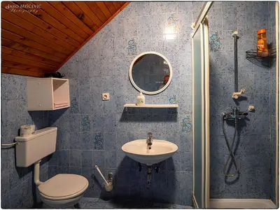 a bathroom with a toilet and a sink at Turistična kmetija Markun in Golnik