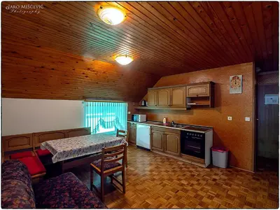 a kitchen with a table and a counter top at Turistična kmetija Markun in Golnik