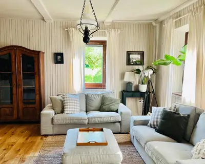 a living room with two couches and a table at House 44 in Bled