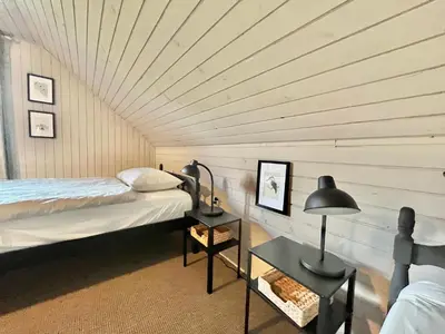 a room with a bed and a table with a lamp at House 44 in Bled