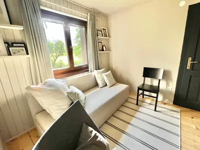 a living room with a couch and a window at House 44 in Bled