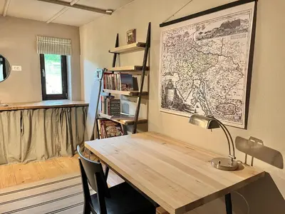 a room with a desk with a map on the wall at House 44 in Bled