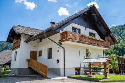 a house with a balcony on top of it at Apartma Mimi in Radovljica