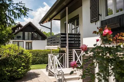 a house with stairs and flowers in front of it at Apartments Villa AnnaMaria in Bled
