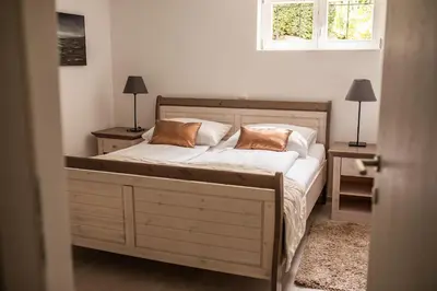 a bedroom with a bed with two pillows on it at Apartments Villa AnnaMaria in Bled