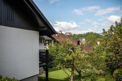 a view from a balcony of a house with trees at Apartments Villa AnnaMaria in Bled