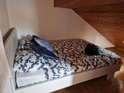 a bed with pillows on it in a room at Zoya Bled Apartments in Bled