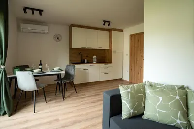 a living room and kitchen with a table and a couch at Zoya Bled Apartments in Bled