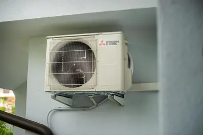 a white air conditioner is hanging on a wall at Zoya Bled Apartments in Bled