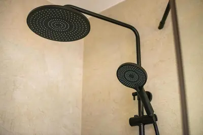 a shower head with a microphone on a wall at Zoya Bled Apartments in Bled