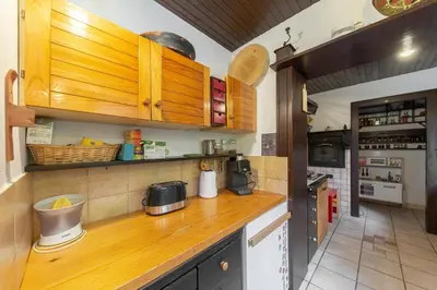 a kitchen with a wooden counter top and wooden cabinets at First House - Lovely Holiday Home near Cerknica in Nova Vas
