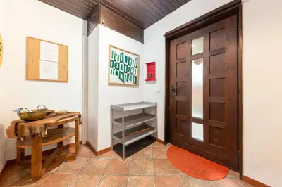 a hallway with a wooden door and a table at First House - Lovely Holiday Home near Cerknica in Nova Vas