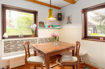 a dining room with a wooden table and chairs at First House - Lovely Holiday Home near Cerknica in Nova Vas