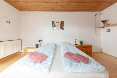 a bedroom with two beds with towels on them at First House - Lovely Holiday Home near Cerknica in Nova Vas