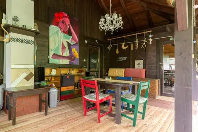 a dining room with a table and colorful chairs at First House - Lovely Holiday Home near Cerknica in Nova Vas