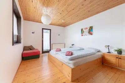 a bedroom with a bed and a wooden ceiling at First House - Lovely Holiday Home near Cerknica in Nova Vas