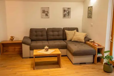 a living room with a couch and a coffee table at Cottage in Novo Mesto 50797 in Novo Mesto
