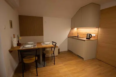 a small kitchen with a small table and a table and chairs at Cottage in Novo Mesto 50797 in Novo Mesto
