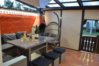 a patio with a table with two bottles of wine at Aparthouse SUPREME with Terme Catez Swimming Pools Tickets in Čatež ob Savi