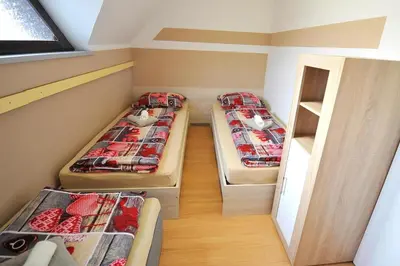 a room with three bunk beds and a window at Aparthouse SUPREME with Terme Catez Swimming Pools Tickets in Čatež ob Savi