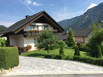 a house with a garden and a driveway at Počitniško stanovanje ZALAR in Mojstrana
