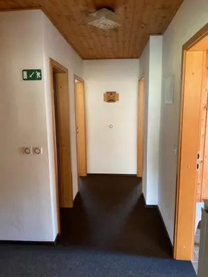 an empty room with a hallway with two doors at Počitniško stanovanje ZALAR in Mojstrana