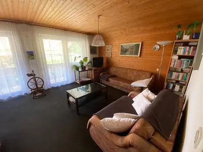 a living room with a couch and a table at Počitniško stanovanje ZALAR in Mojstrana