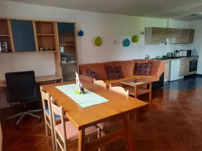 a living room with a table and a couch at Apartma Grlica in Selnica ob Muri