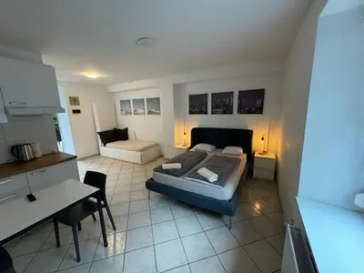 a bedroom with a bed and a desk in a room at Cozy flat near Tivoli park with free parking in Ljubljana