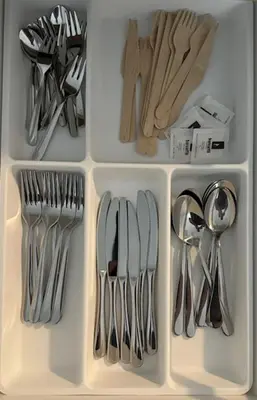 a drawer filled with silver utensils in a refrigerator at Cozy flat near Tivoli park with free parking in Ljubljana