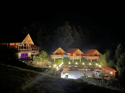an aerial view of a large house at night at Resort pri Hrastu in Kamnik