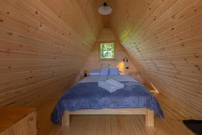 a bedroom with a bed in a log cabin at Resort pri Hrastu in Kamnik