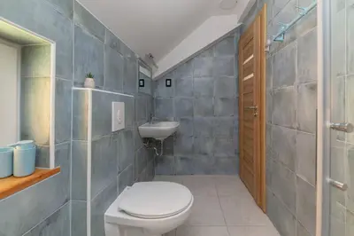 a bathroom with a toilet and a sink at Resort pri Hrastu in Kamnik