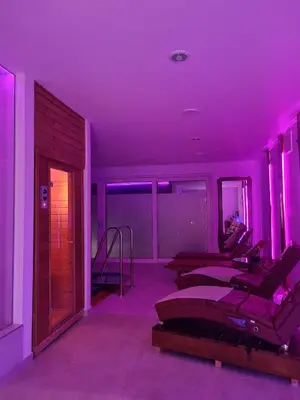 a room with purple lights and beds in it at Resort pri Hrastu in Kamnik