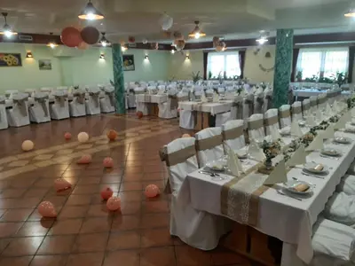 a banquet hall with white tables and white chairs at Posestvo Rožengrunt pri Miheliču in Lokavec