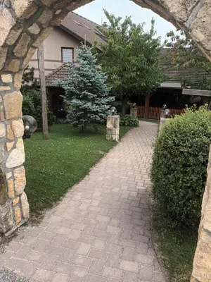 a brick walkway in front of a house at Posestvo Rožengrunt pri Miheliču in Lokavec