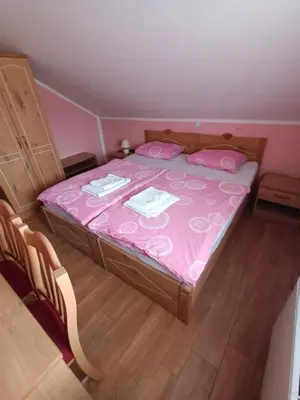 a small bedroom with a pink bed with pink sheets at Posestvo Rožengrunt pri Miheliču in Lokavec