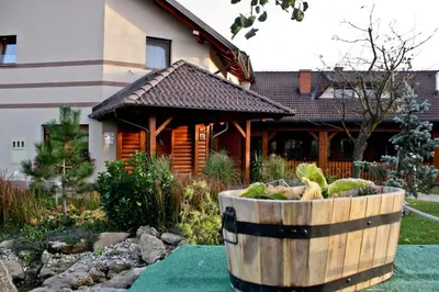 a wooden barrel filled with vegetables in front of a house at Posestvo Rožengrunt pri Miheliču in Lokavec
