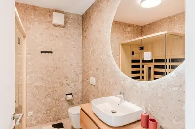 a bathroom with a sink and a mirror at Apartment Hajdi with Sauna & Garage in Bovec