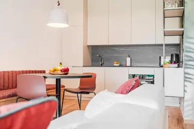 a kitchen and living room with a table and chairs at Apartment Hajdi with Sauna & Garage in Bovec