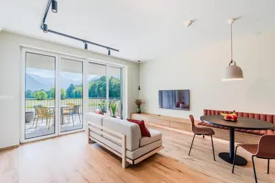a living room with a couch and a table at Apartment Hajdi with Sauna & Garage in Bovec