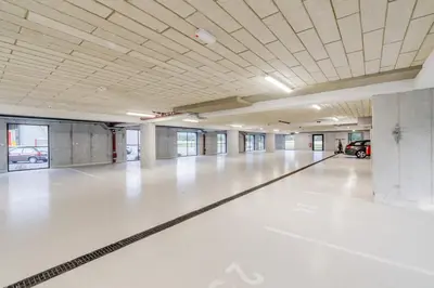a large empty parking garage with a car parked in it at Apartment Hajdi with Sauna & Garage in Bovec
