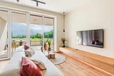 a living room with a couch and a tv at Apartment Hajdi with Sauna & Garage in Bovec