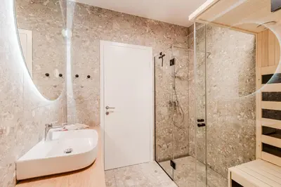 a bathroom with a sink and a shower at Apartment Hajdi with Sauna & Garage in Bovec
